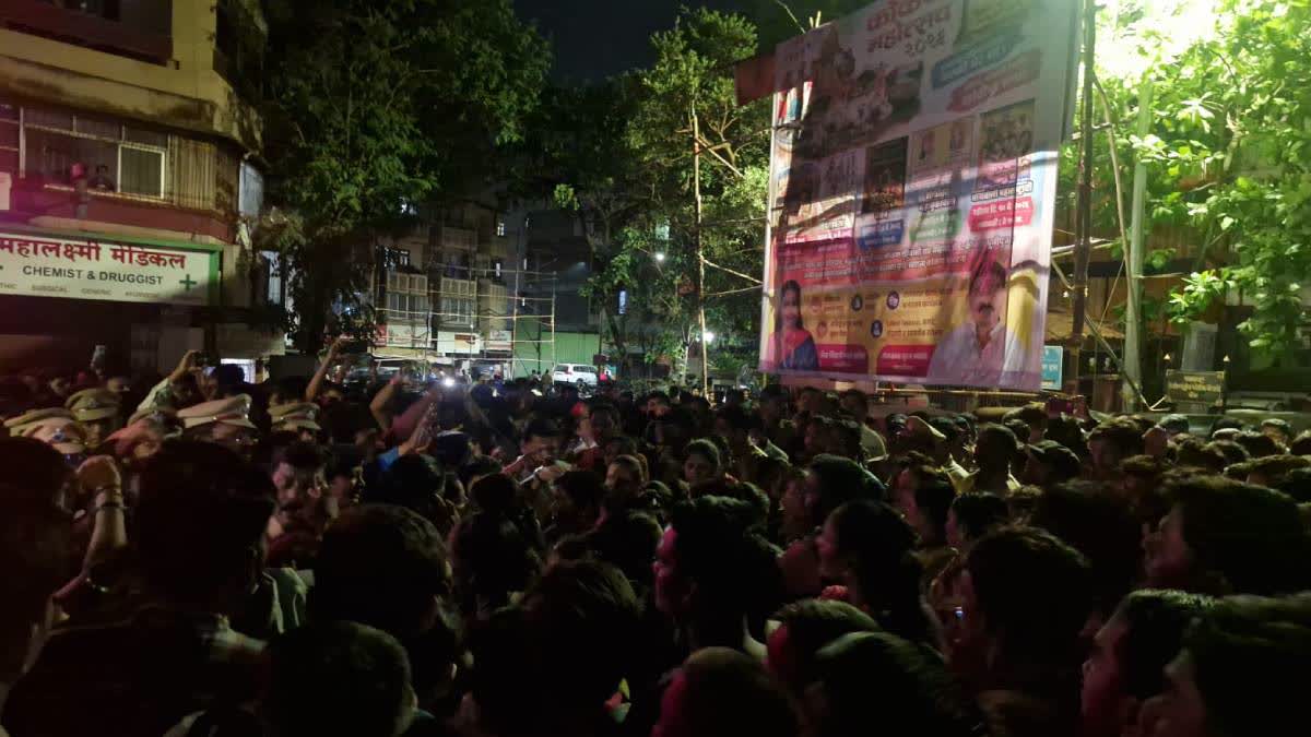 Locals protest outside the Datta Wadi police station.