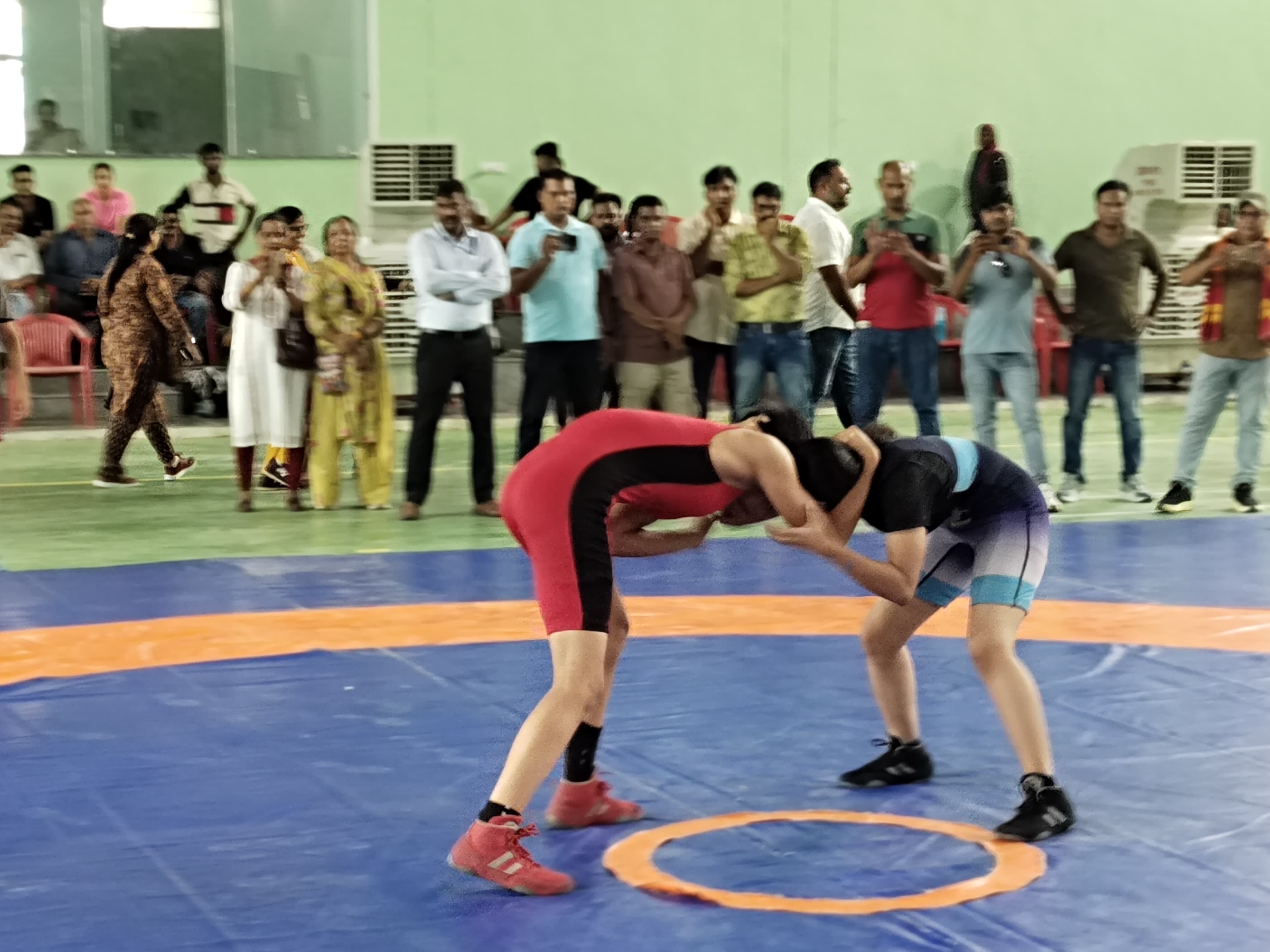 Wrestlers displaying their strength in the arena.