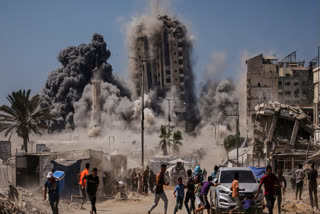 Palestinians run for cover during an Israeli airstrike on a high-rise building in Gaza City, Friday, Sept. 5, 2025, after the Israeli army issued a prior warning.
