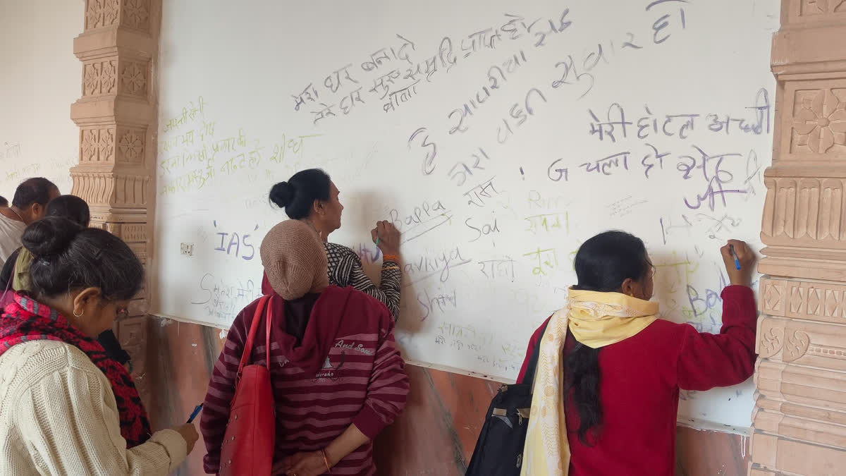 Devotees write their requests on the wall