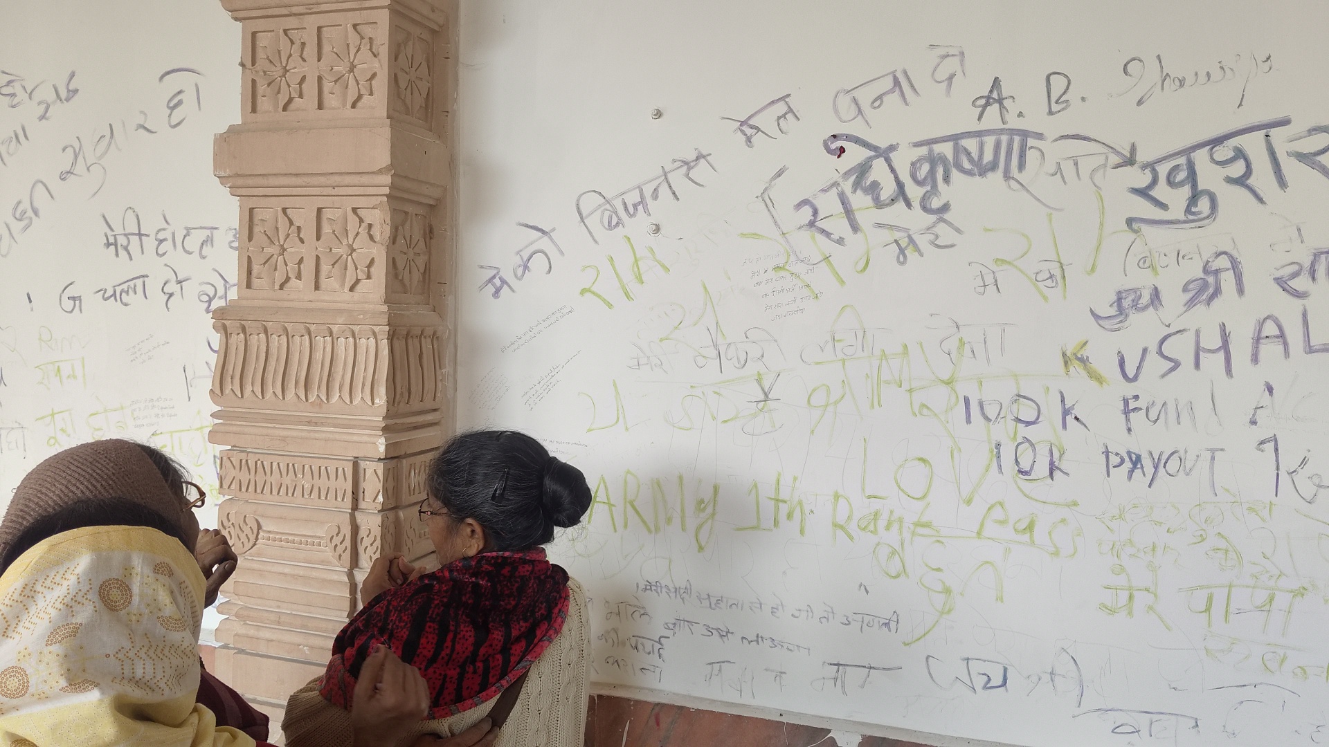 Female devotees writing their requests