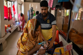 A mother administers a nebulizer treatment for her child suffering from measles at the Infectious Diseases Hospital in Dhaka, Bangladesh, Monday, April 6, 2026, amid a countrywide outbreak.