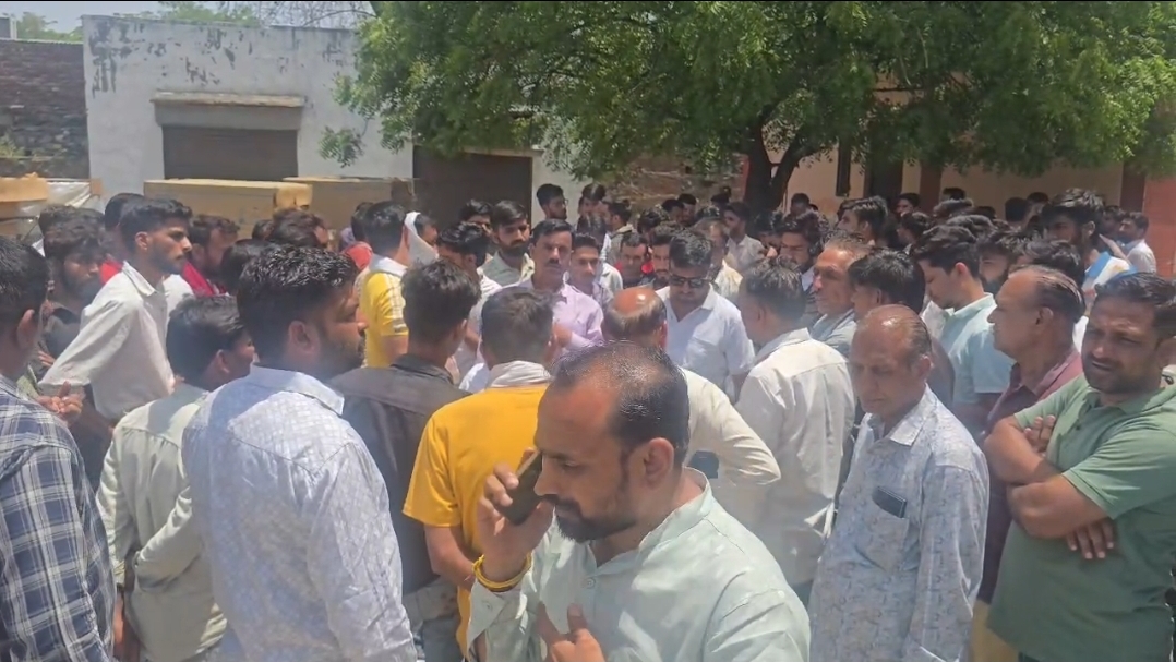 Crowd of villagers gathers at the mortuary