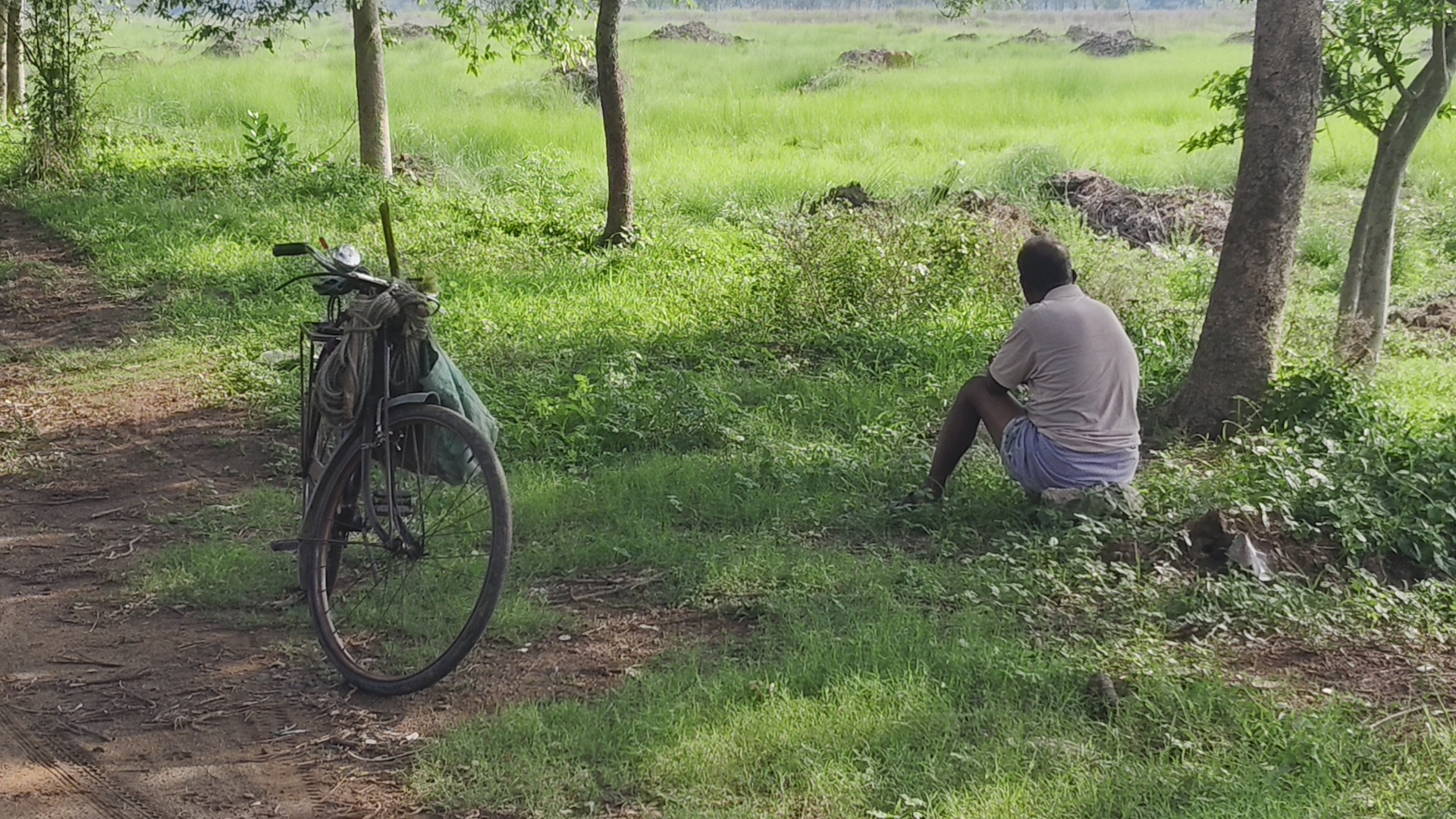 A farmer sits beside his land acquired for industrialistion in Singur.