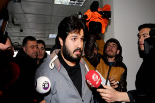 FILE - In this Tuesday, Dec. 17, 2013 photo, Turkish-Iranian businessman Reza Zarrab, who is charged currently in the U.S. for evading sanctions on Iran, is surrounded by the media members as he arrives at a courthouse in Istanbul, in a separate case against him.