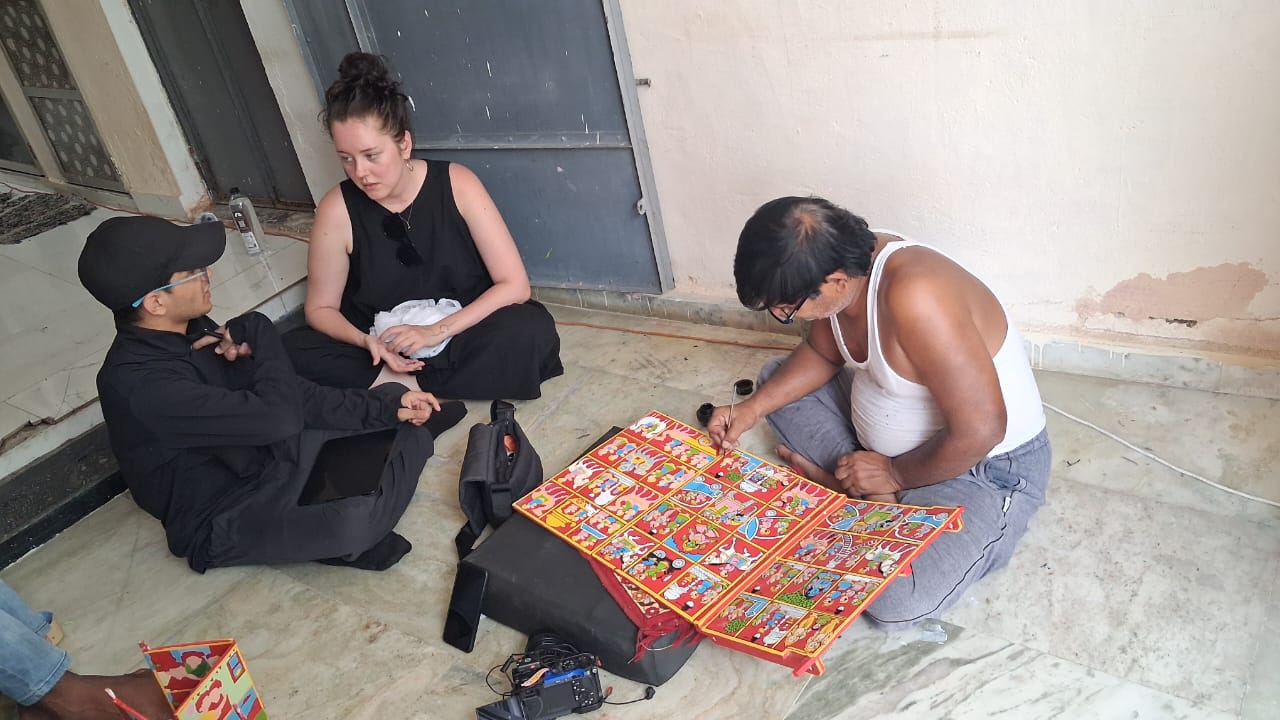 Researchers discussing the art of Kawad