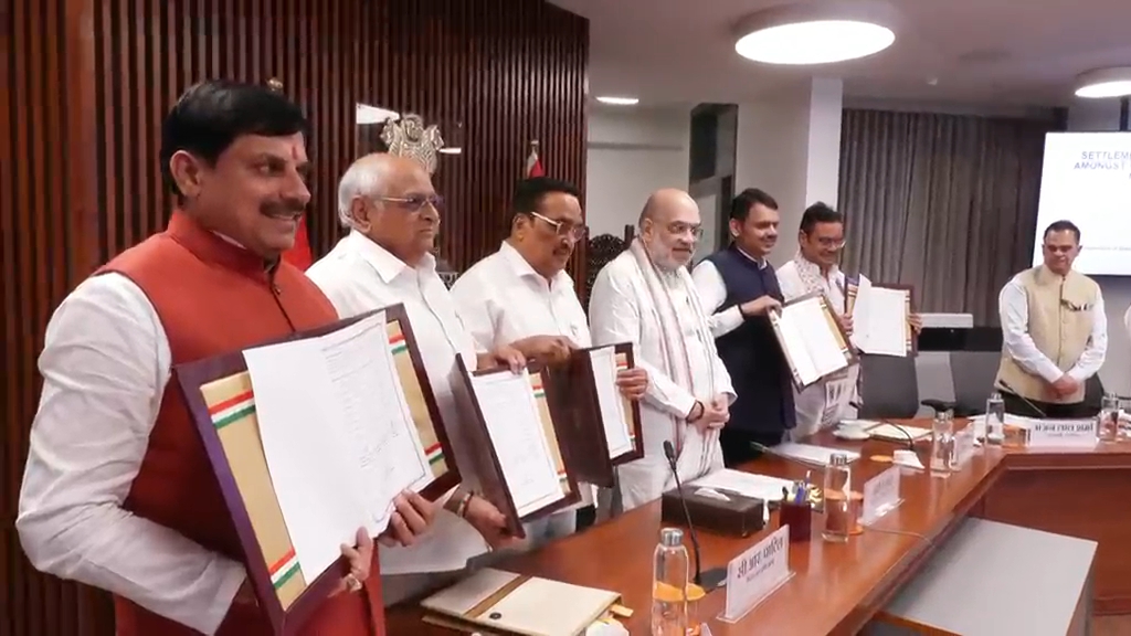 Chief Minister showing a copy of the agreement