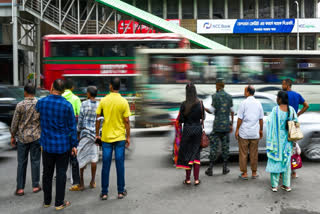 Commuters wait at a traffic light in Dhaka on August 7, 2024, after former prime minister Sheikh Hasina fled the country.
