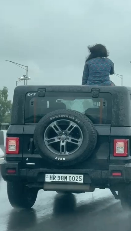Girl made a reel by climbing on the roof of a Thar on NH48 highway in Gurugram