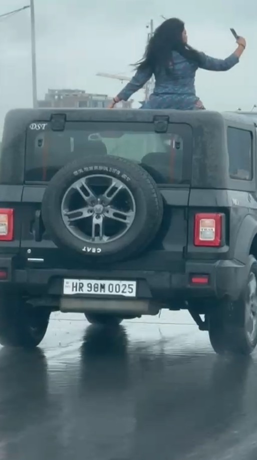 Girl made a reel by climbing on the roof of a Thar on NH48 highway in Gurugram