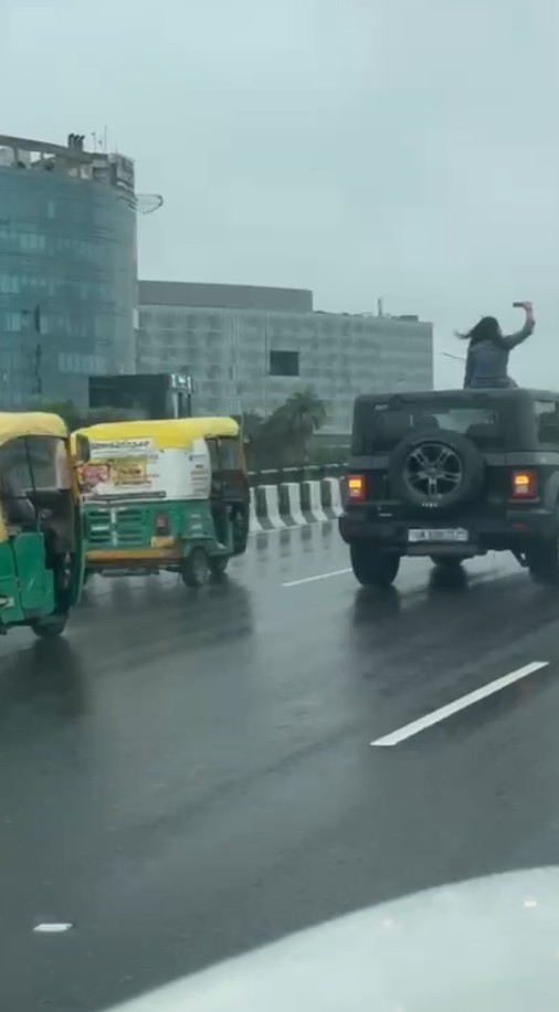 Girl made a reel by climbing on the roof of a Thar on NH48 highway in Gurugram
