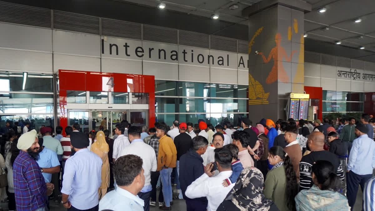People wait outside the arrivals exit at the Indira Gandhi International (IGI) Airport, in New Delhi, Friday, Nov. 7, 2025.