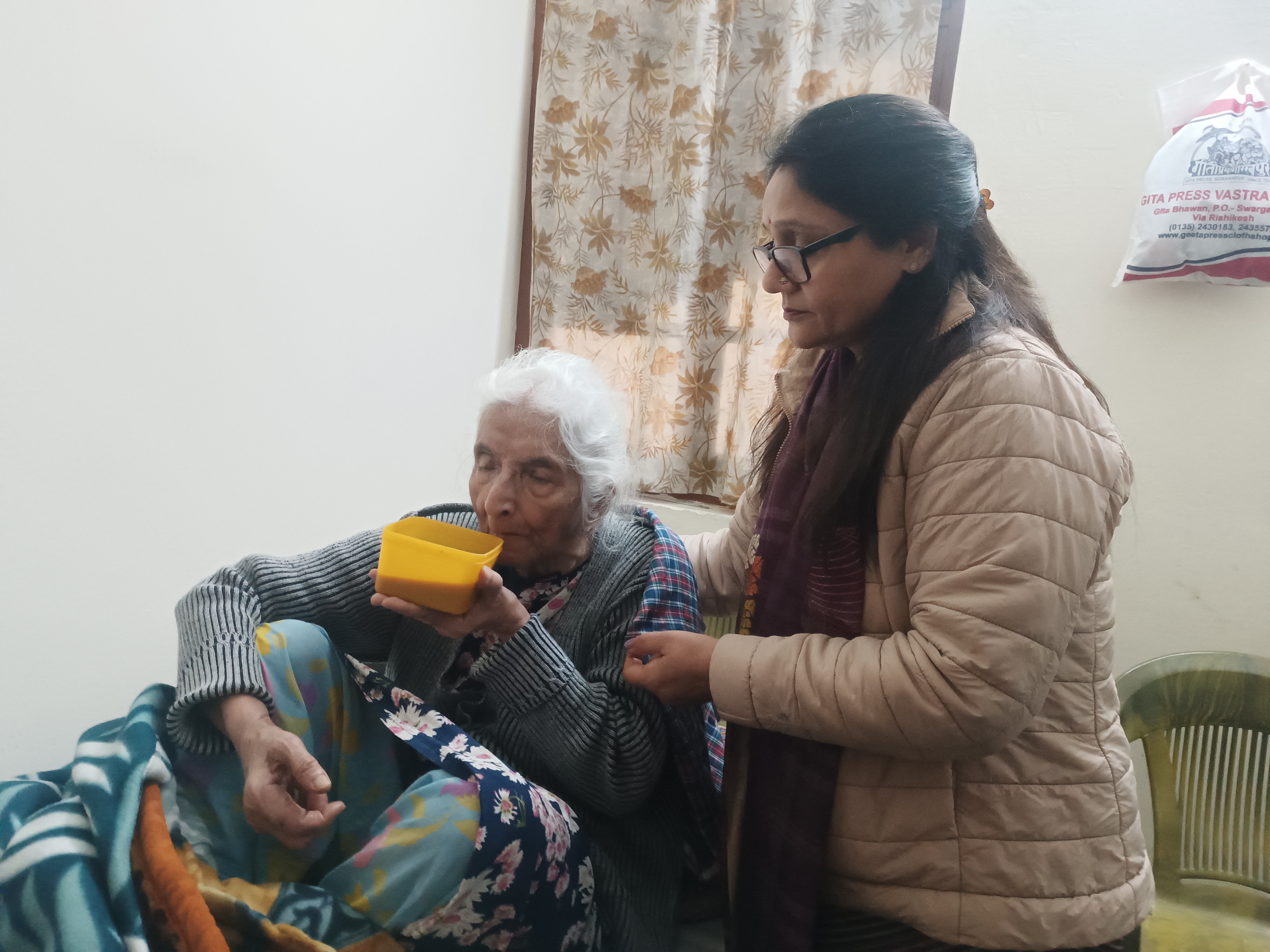 Octogenarian Pushpa Munjiyal (L) being looked after at Prem Dham Ashram in Dehradun, Uttarakhand