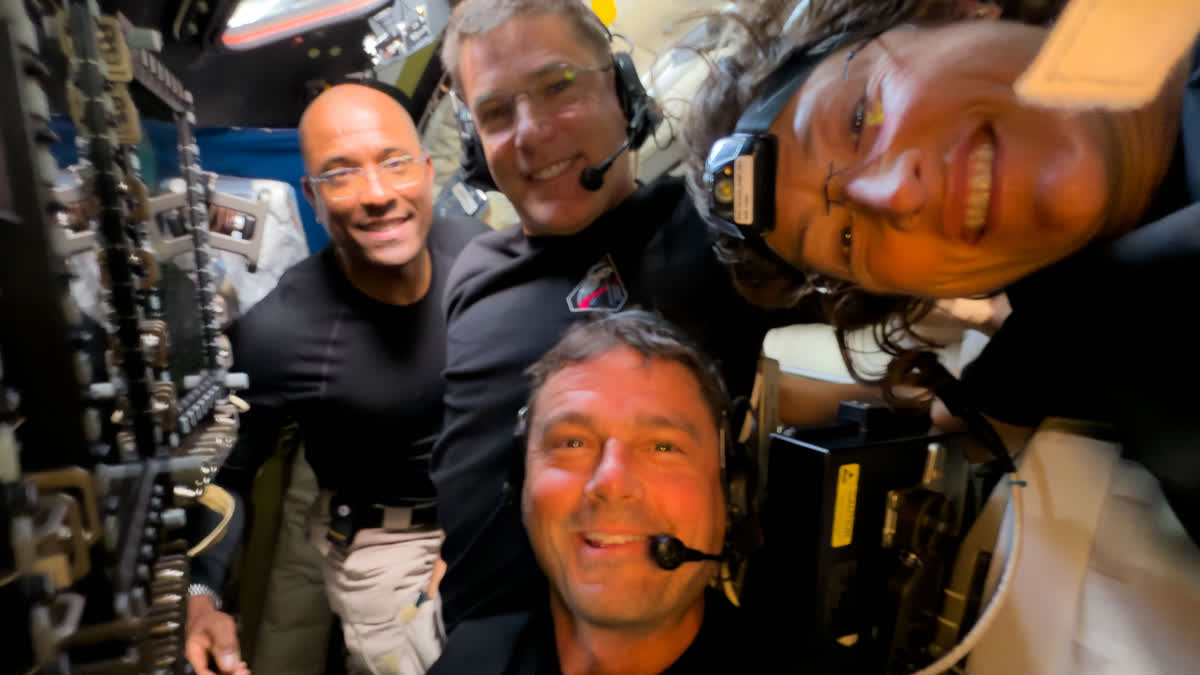 The Artemis II crew members, from left, Victor Glover, Jeremy Hansen, Reid Wiseman and Christina Koch, pause to turn the camera around for a selfie midway through their lunar observation period of the Moon during a lunar flyby