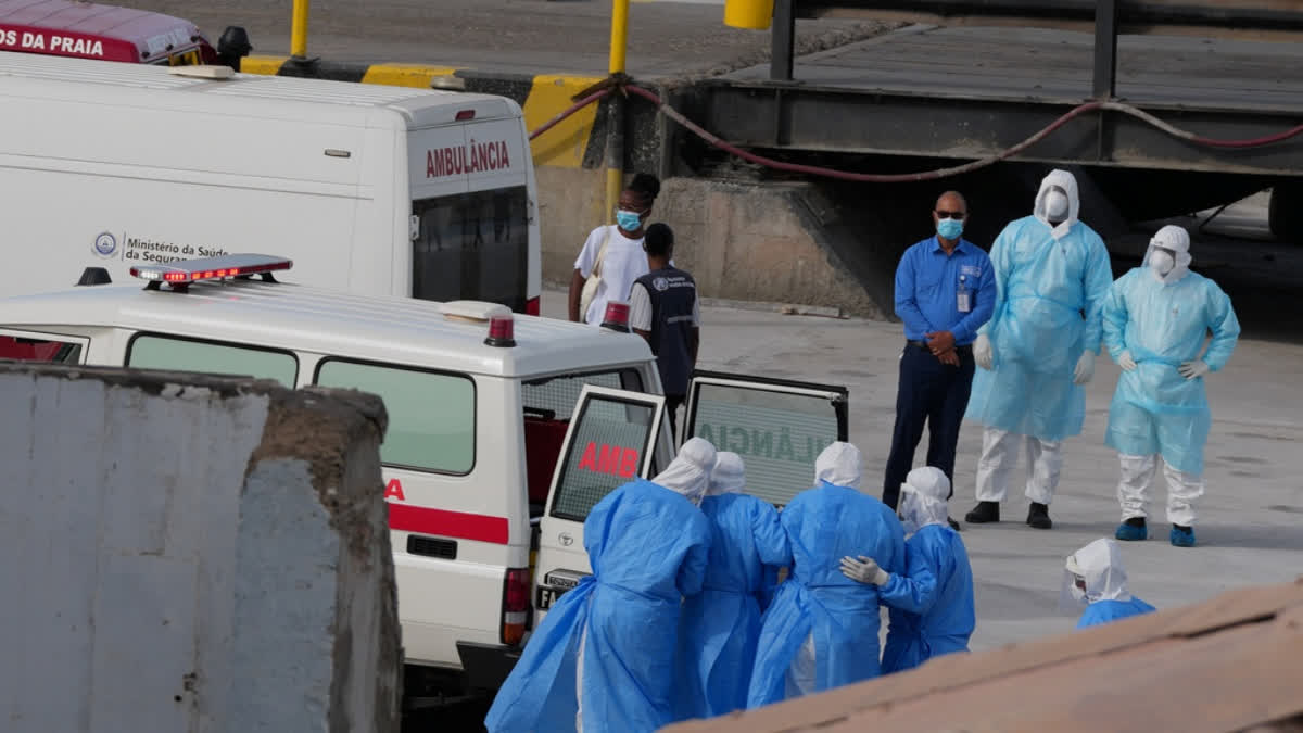 Health workers in protective gear evacuate patients from the MV Hondius cruise ship into an ambulance at a port in Praia, Cape Verde, Wednesday, May 6, 2026.