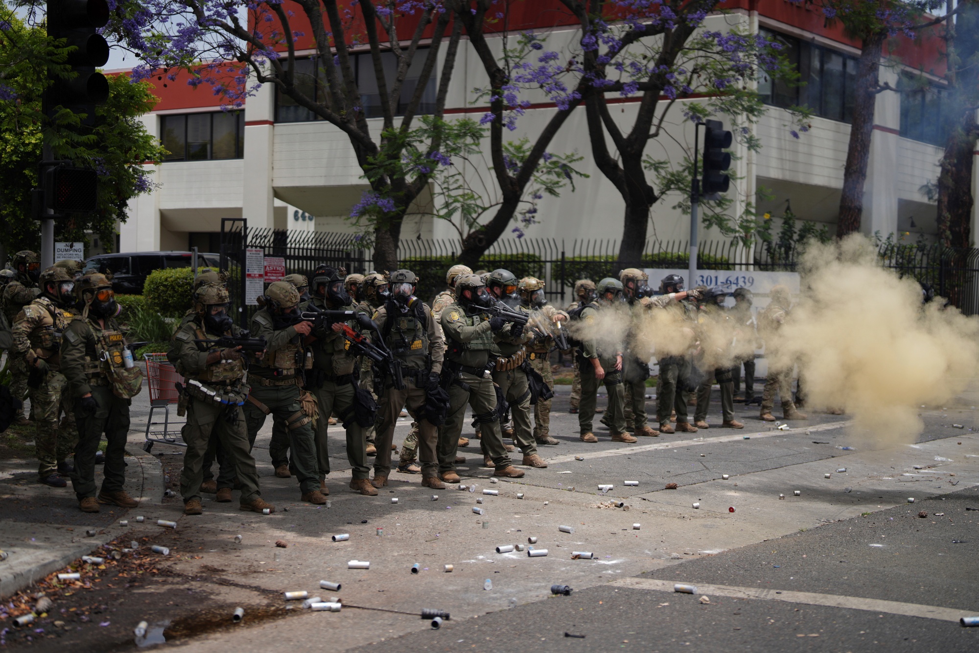Border Patrol personnel deploy tear gas during a demonstration over the dozens detained in an operation by federal immigration authorities a day earlier in Paramount section of Los Angeles Saturday, June 7, 2025.
