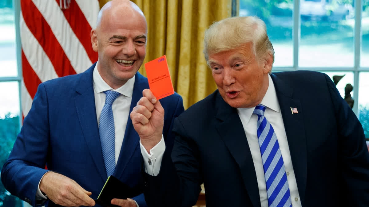 FILE - President Donald Trump holds up a red card during a meeting with FIFA president Gianni Infantino in the Oval Office of the White House, Tuesday, Aug. 28, 2018, in Washington.