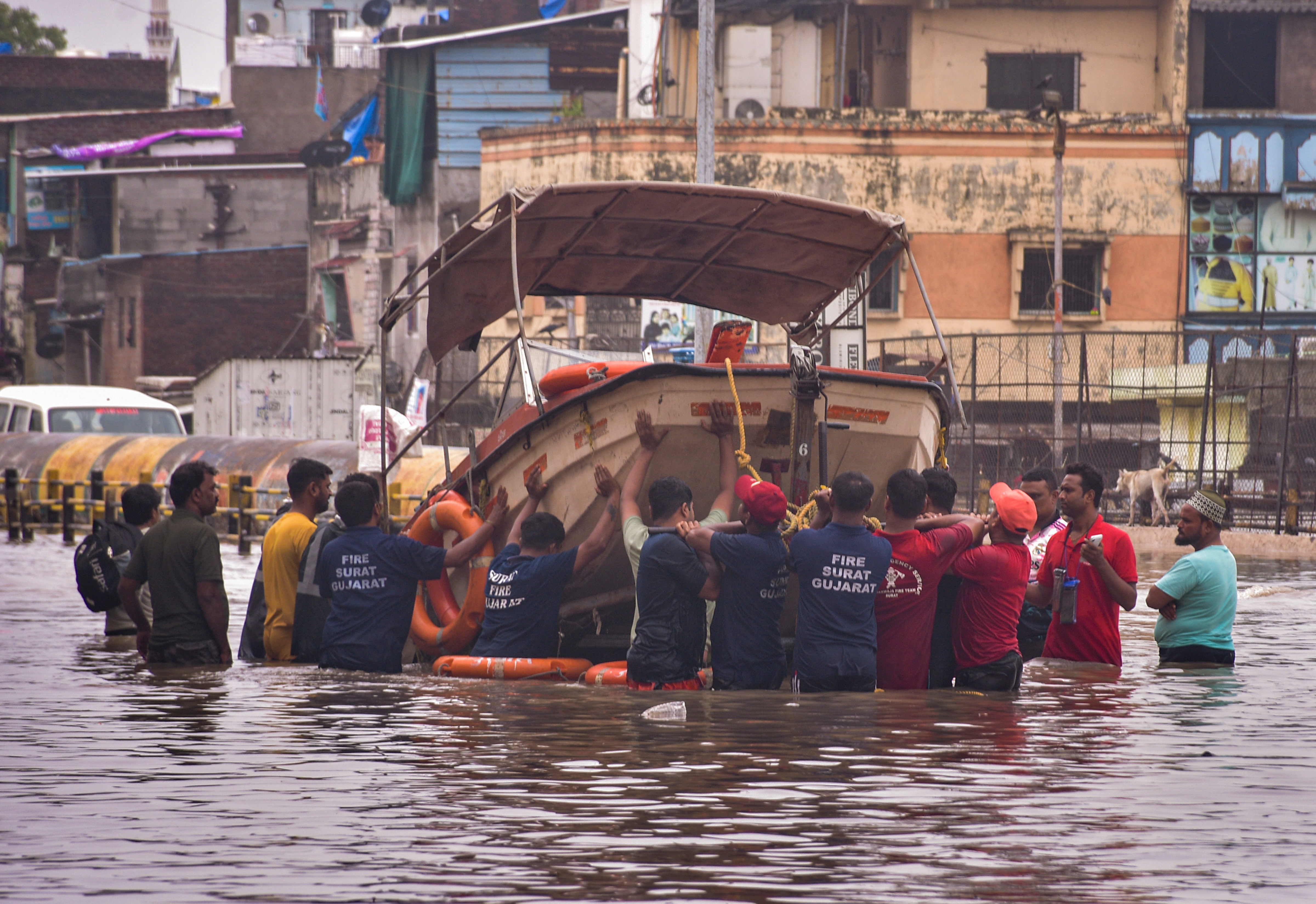Fire and emergency services personnel deploy a rescue boat in the flood-affected Limbayat Mithi Khadi area following heavy monsoon rainfall, in Surat, on Wednesday.