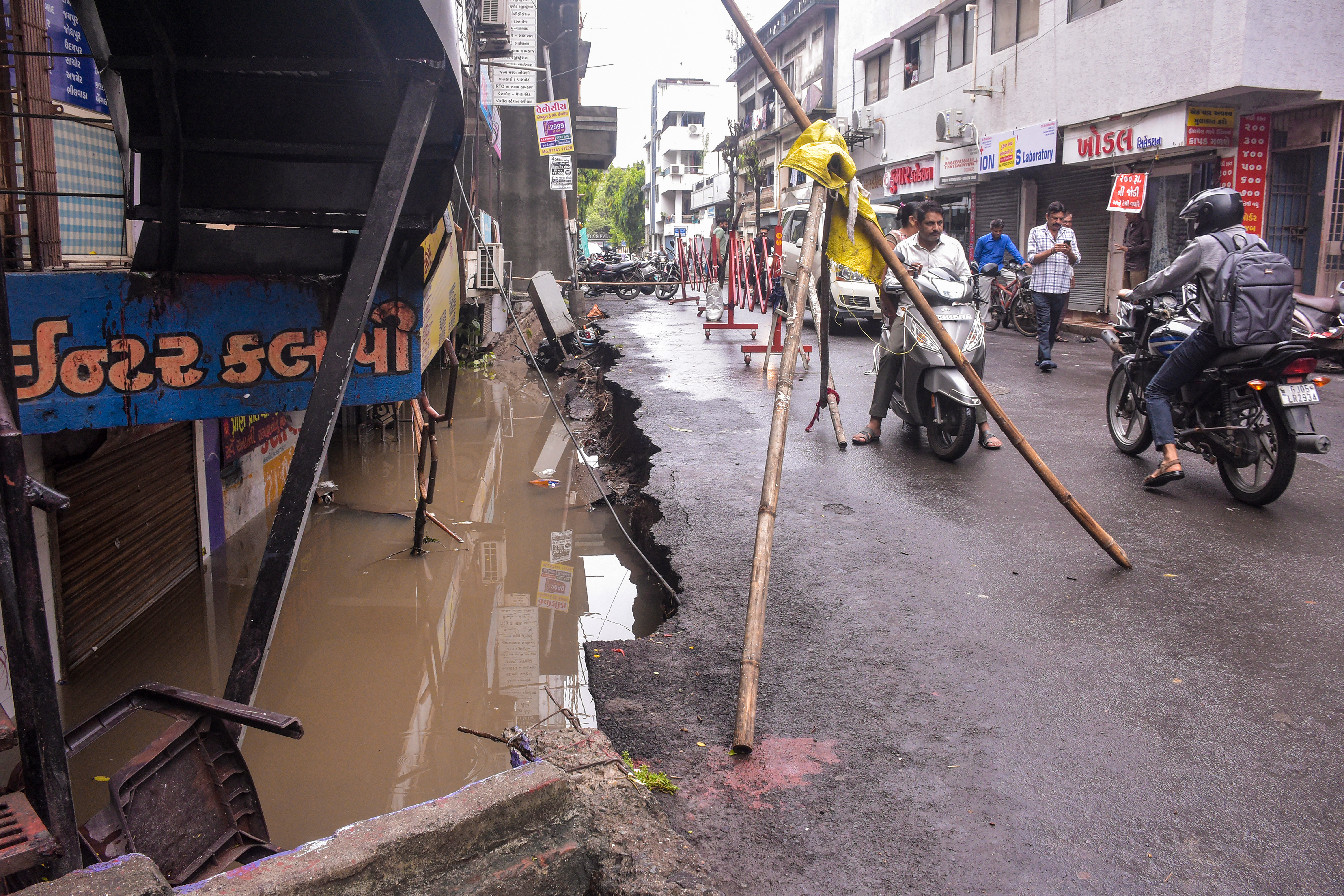 A collapsed road following heavy rainfall in the Katargam area of Surat on Wednesday.