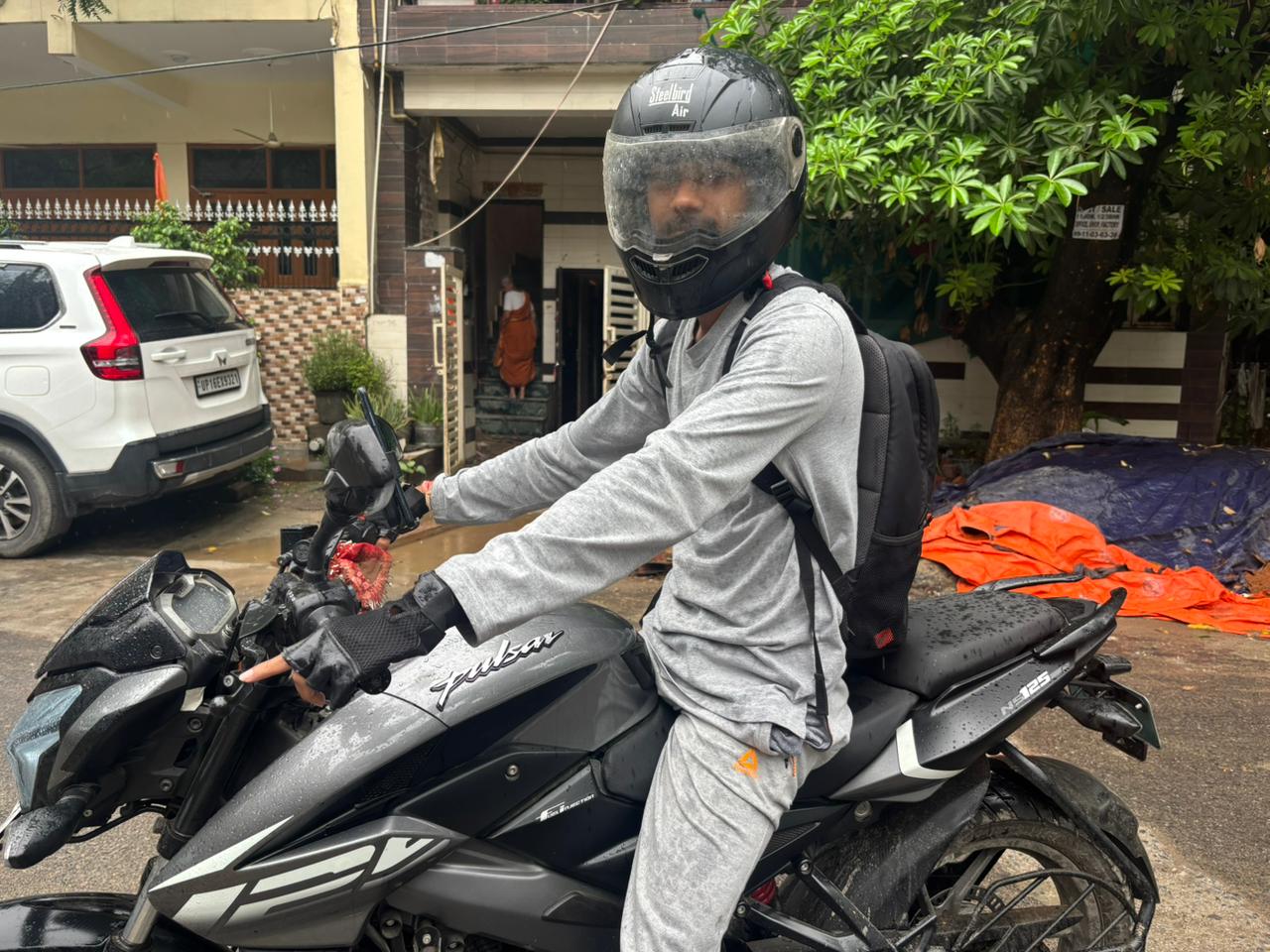 A bike taxi rider on his way to pick up a commuter in rain on Wednesday.