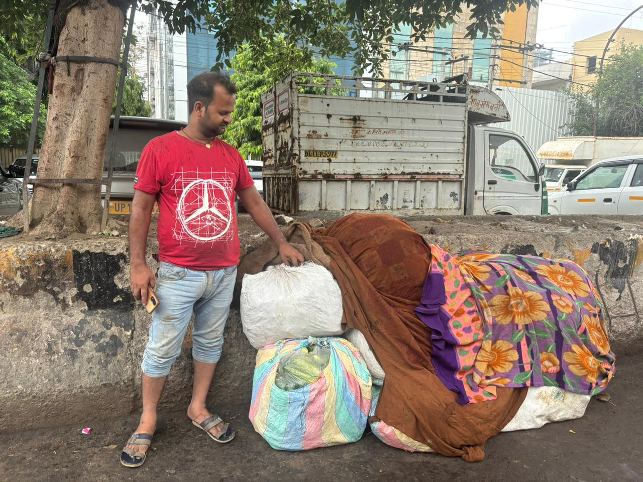A vegetable vendor waits for rain to stop in Delhi.