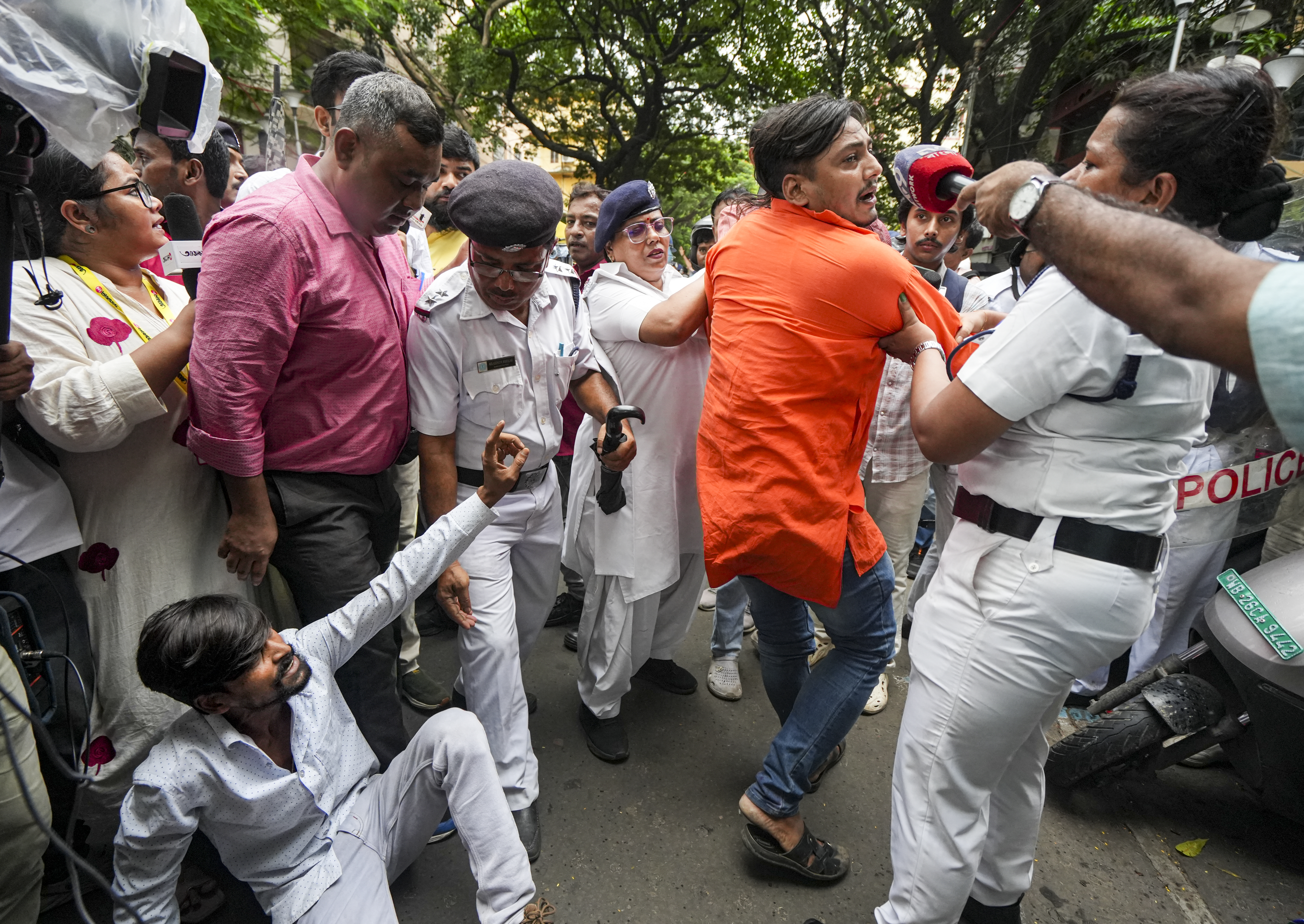 Police taking away TMC worker.