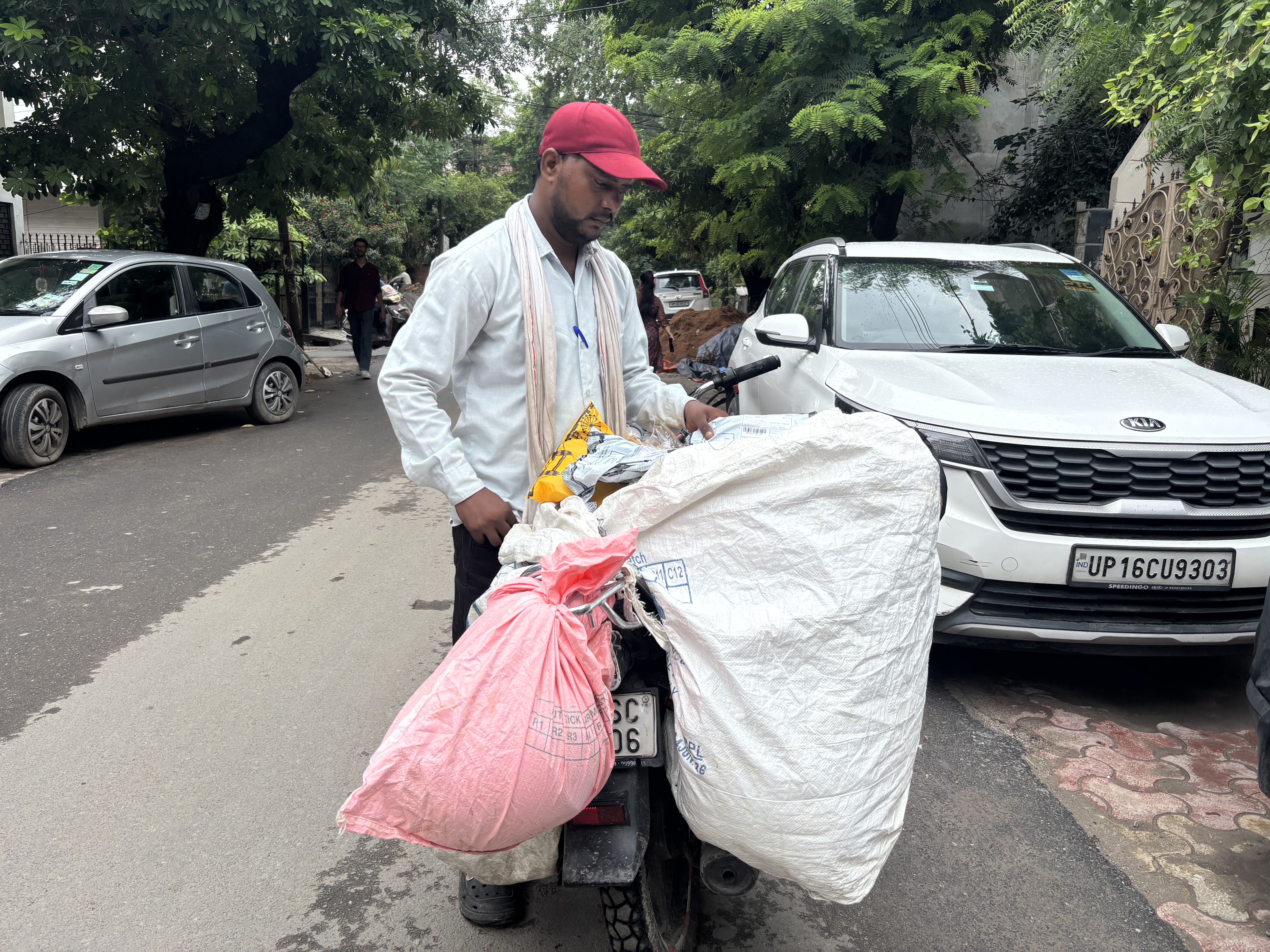 A delivery executive continues delivering goods during the monsoon rain in Delhi.