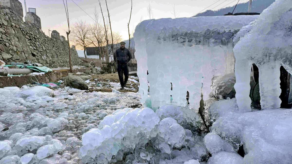 A man walks past icicles hanging from a structure amid heavy frost and snow cover during a cold wave in the valley, in Anantnag district, Jammu and Kashmir, Friday, January 9, 2026