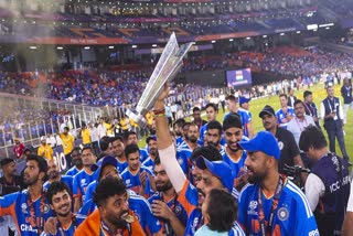 India's Mohammed Siraj, Axar Patel and others celebrate with the tournament trophy after India won the ICC Men's T20 World Cup 2026 at Narendra Modi Stadium, in Ahmedabad, Sunday, March 8, 2026.