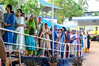 Voters wait in queues to cast their votes during the Kerala Assembly election at Jawahar Nagar LPS, in Thiruvananthapuram, Kerala on Thursday