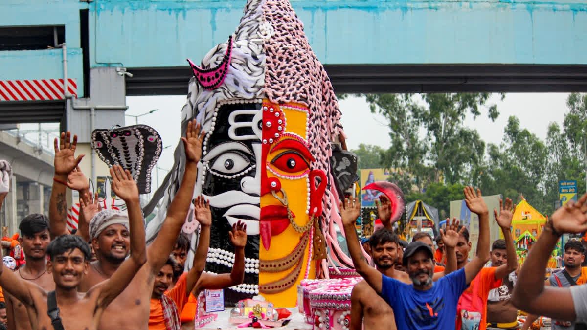 'Kanwariyas' with a tableau during the 'Kawar Yatra' to observe the holy month of 'Shravan.