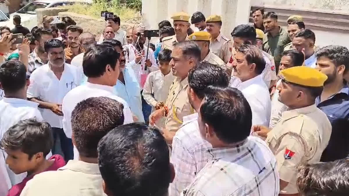 Police officer speaking with MLA Yunus Khan in Didwana.