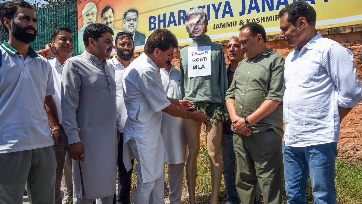 BJP workers with an effigy during a protest against National Conference leader Tanvir Sadiq over his recent remark, in Srinagar on Wednesday.