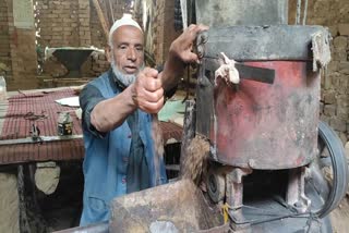 Muhammad Abdullah works at his water mill in Kokernag, Jammu and Kashmir