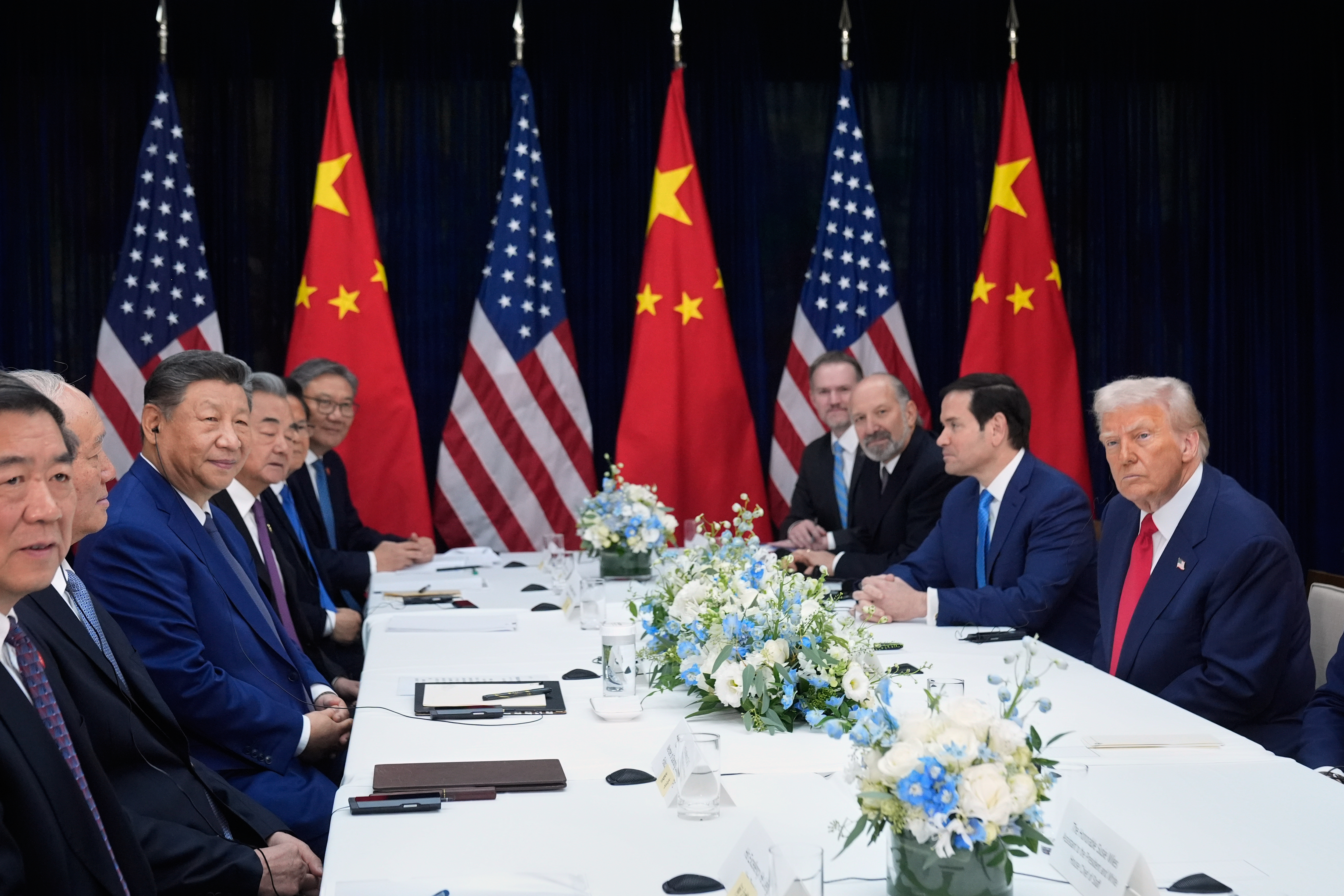 President Donald Trump, right, and Chinese President Xi Jinping, third left, hold their summit talk at Gimhae International Airport in Busan, South Korea, Thursday, Oct. 30, 2025
