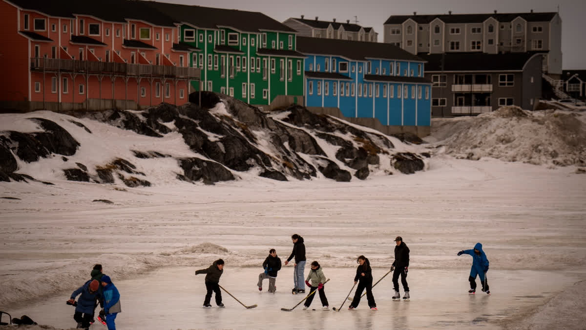 FILE - Children play on an icy surface in Nuuk, Greenland, Feb. 16, 2025.
