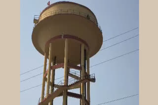Youth climbs on PHED tank