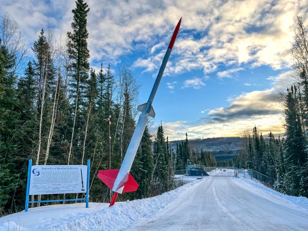 The Poker Flat Research Range entrance near Fairbanks, Alaska, features a model sounding rocket and informational sign