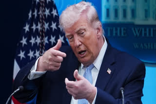 FILE - President Donald Trump pretends to aim a sniper gun while speaking with reporters in the James Brady Press Briefing Room at the White House, Monday, April 6, 2026, in Washington.