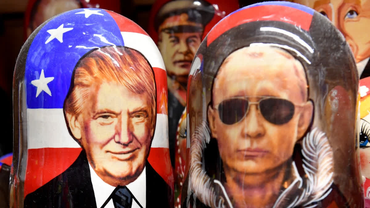 Traditional Russian wooden nesting dolls, Matryoshka dolls, depicting Russia's President Vladimir Putin and US President Donald Trump are displayed for sale in Saint Petersburg on August 7, 2025.