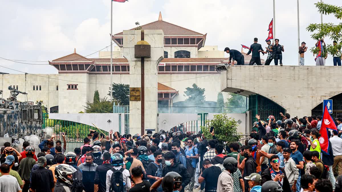 Riot police personnel fire tear gas to disperse demonstrators during a protest outside the Parliament in Kathmandu on September 8, 2025, against social media prohibitions and corruption by the government.