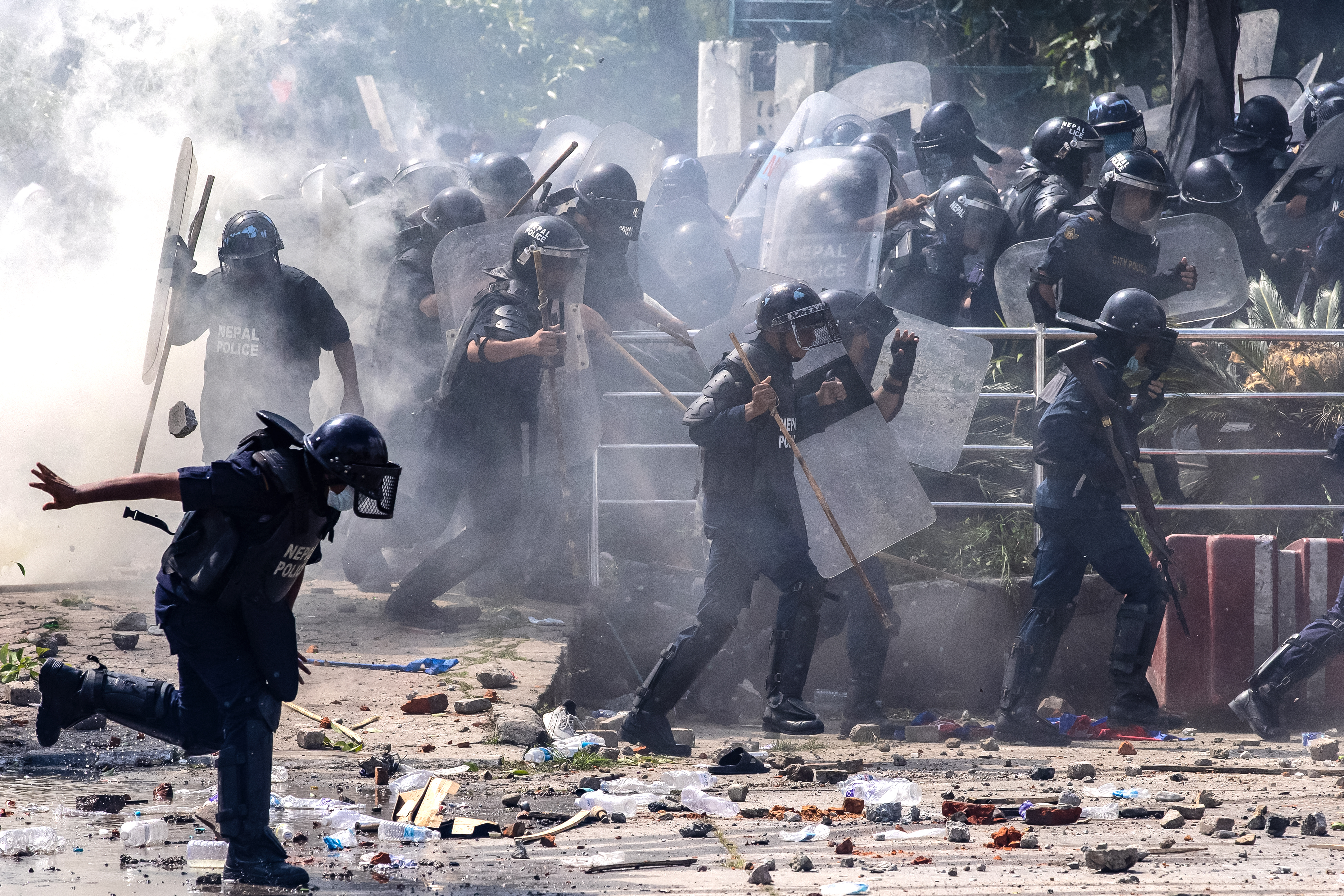 Riot police personnel fire tear gas to disperse demonstrators during a protest outside the Parliament in Kathmandu on September 8, 2025, condemning social media prohibitions and corruption by the government.