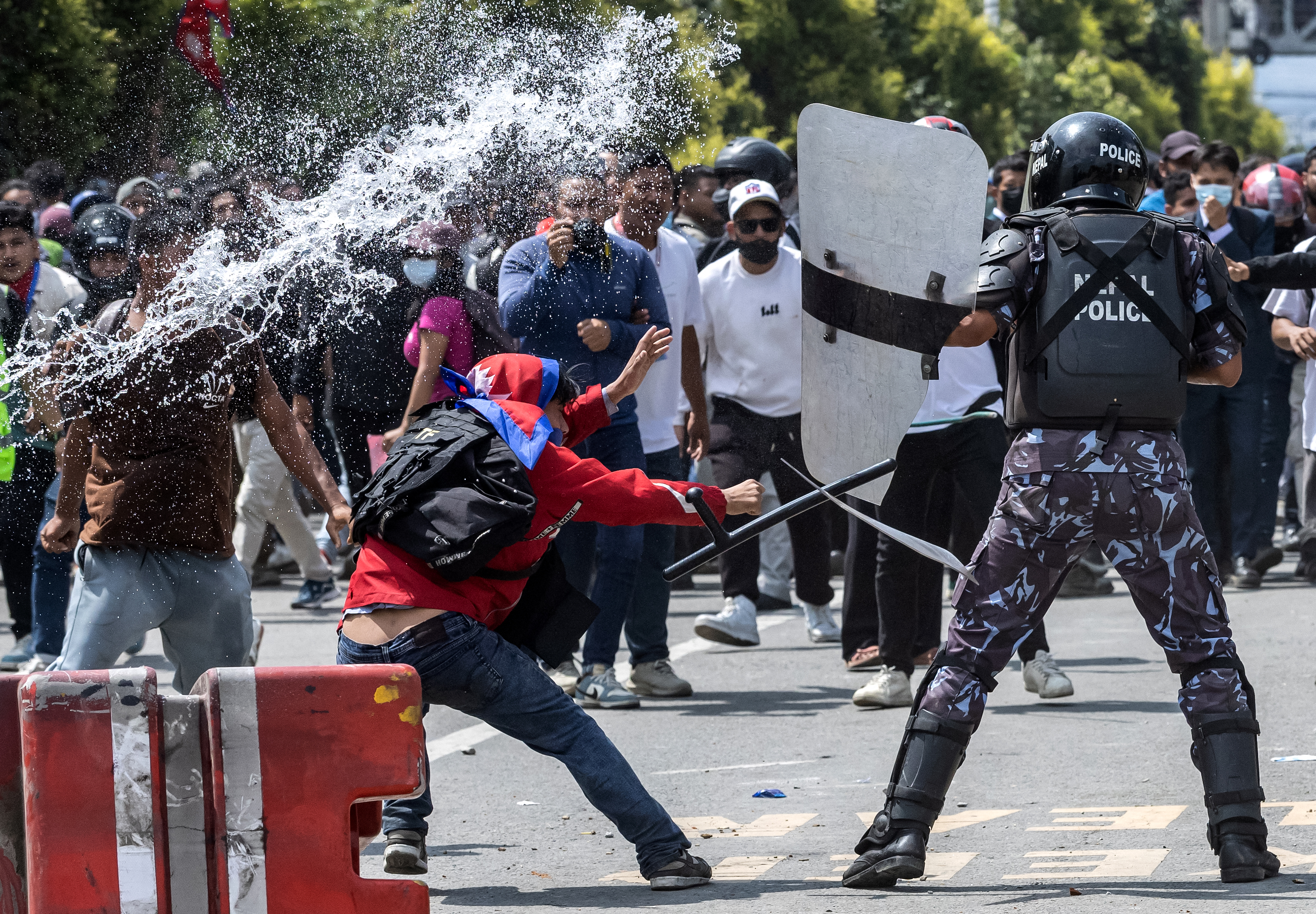 Demonstrators clash with riot police personnel during a protest outside the Parliament in Kathmandu on September 8, 2025, condemning social media prohibitions and corruption by the government.
