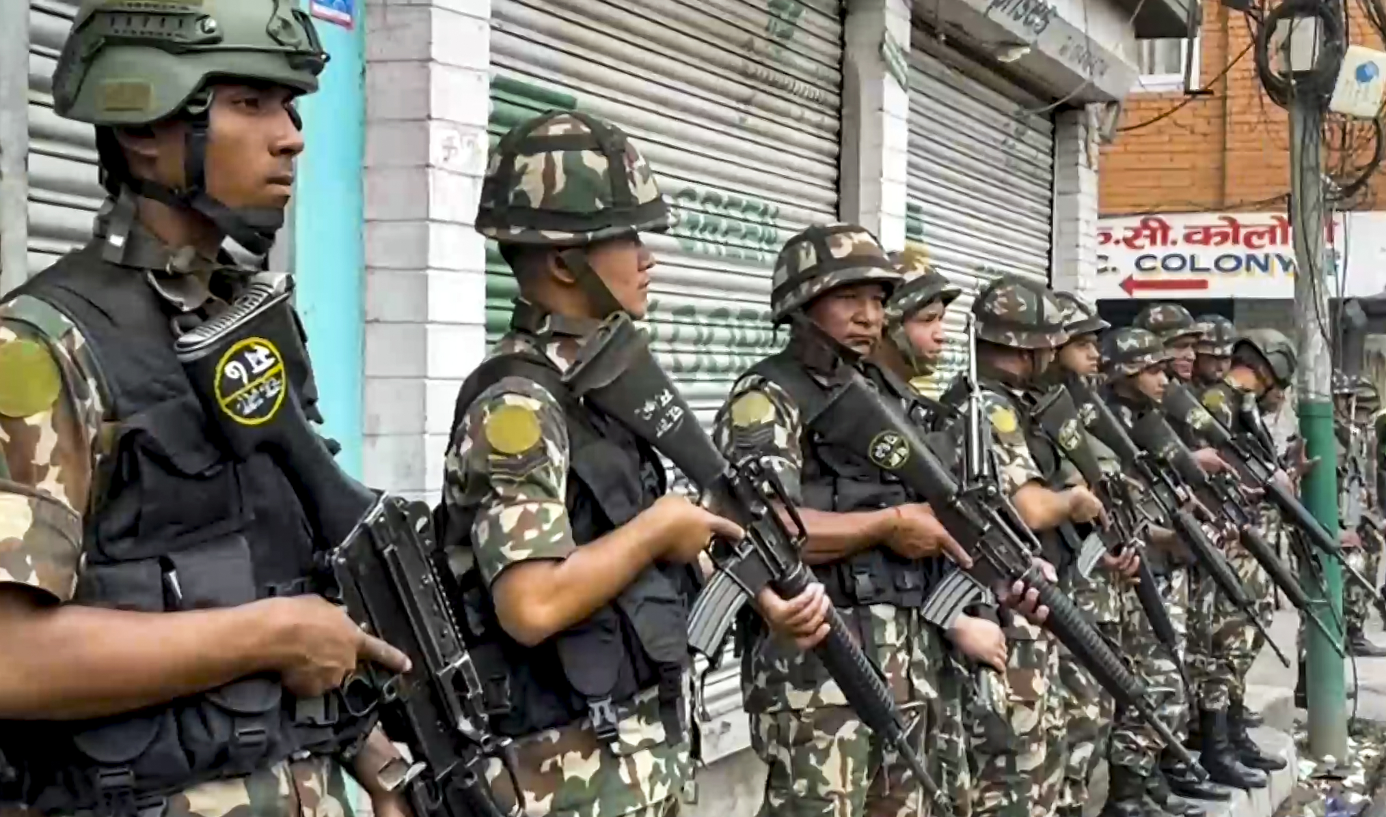 Security personnel stand guard outside the Dillibazar prison after prisoners tried to escape following anti-government protests and clashes, in Kathmandu, Wednesday, Sept. 10, 2025.