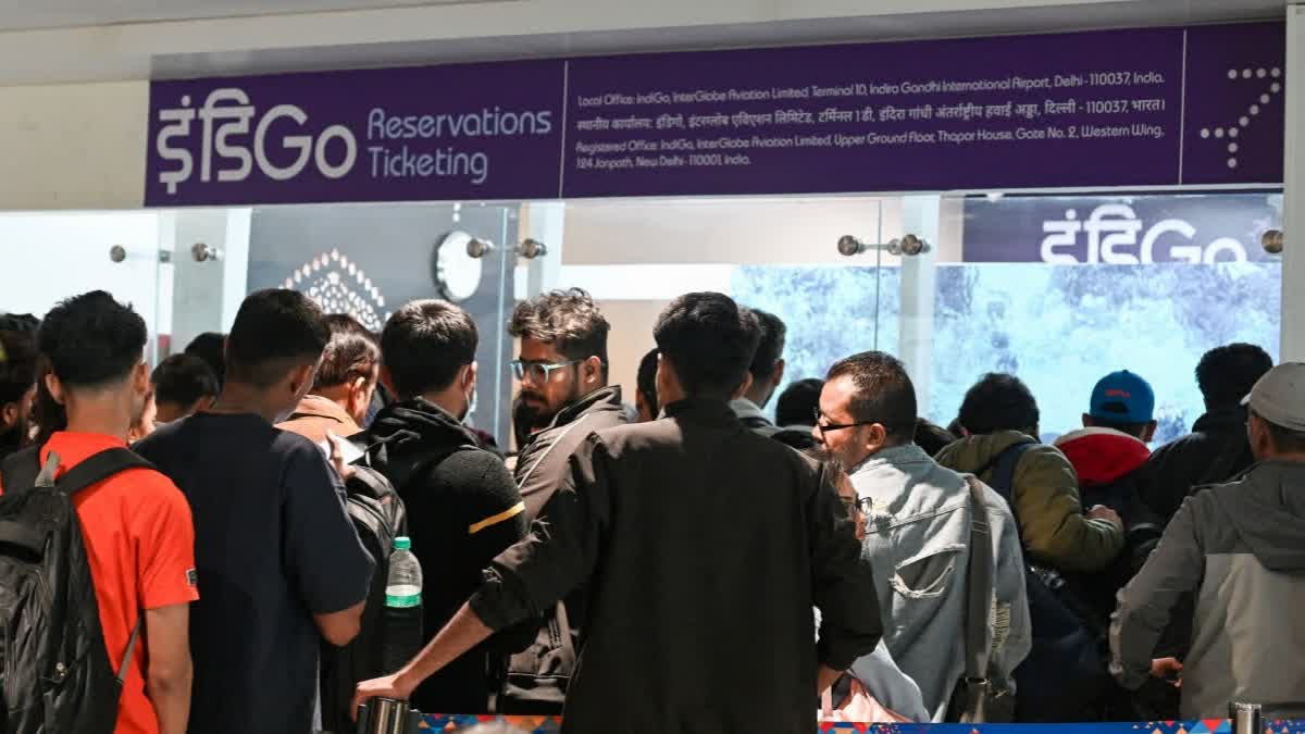 Passengers in a queue at the IndiGo counter as several IndiGo flights continue to be cancelled or delayed at the Indira Gandhi International Airport Terminal 1 in New Delhi