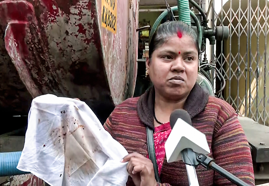 A woman shows a stained piece of cloth from contaminated water at Bhagirathpur area as people suffer from contaminated water, in Indore