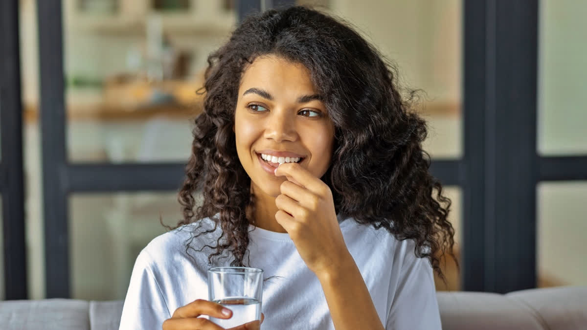 Can A Daily Multivitamin Slow Down Ageing Naturally? New Research Says Yes, Find Out How Much Vitamin Your Body Actually Needs Every Day Young woman taking vitamins