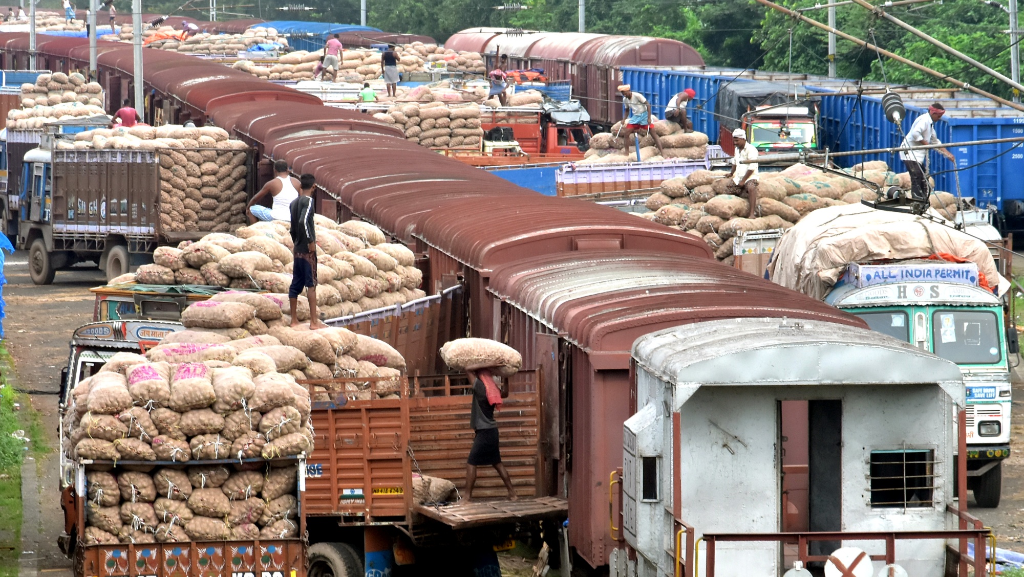 Labours unloading potato sacks from goods train, in Kolkata