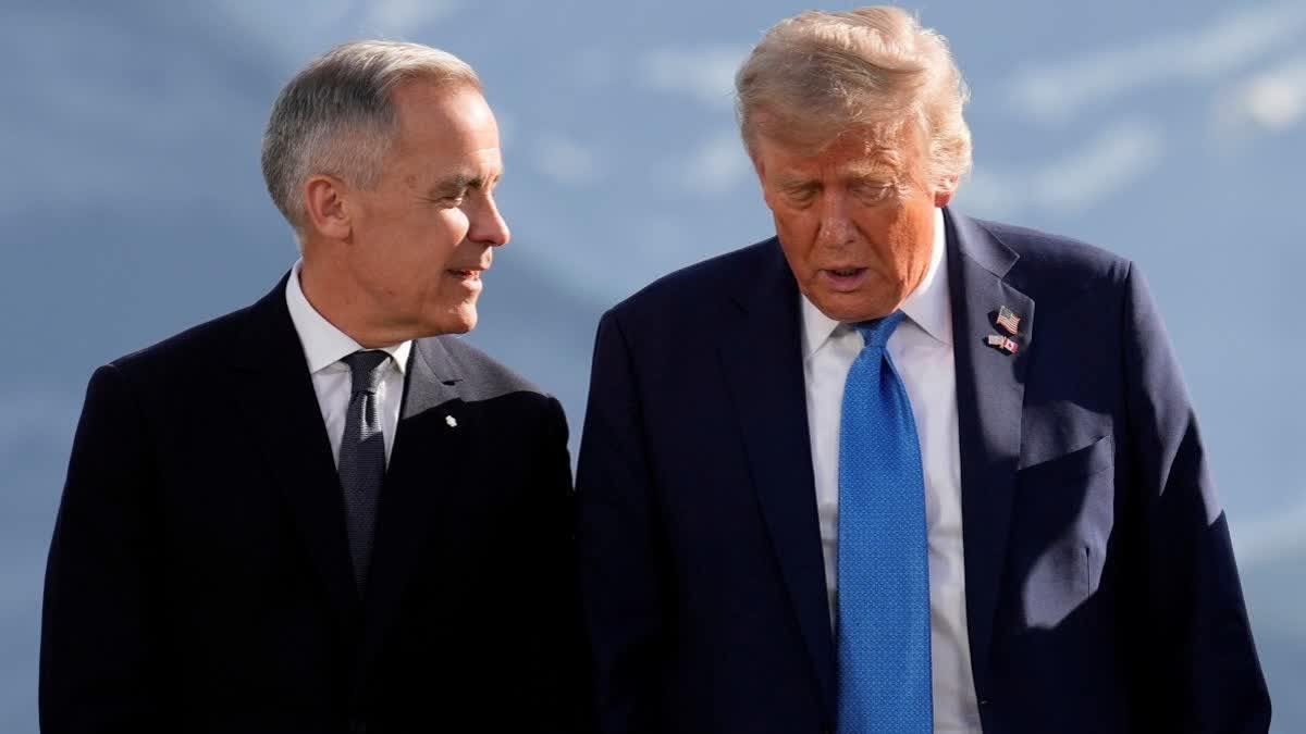 Canada's Prime Minister Mark Carney talks with President Donald Trump before a group photo at the G7 Summit, Monday, June 16, 2025, in Kananaskis, Canada