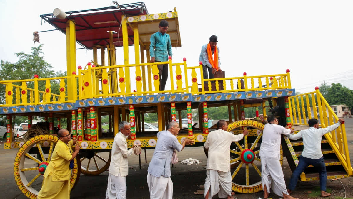 FILE- Devotees busy working chariot construction as part of the preparations ahead of Lord Jagannath Rath Yatra at Patel Nagar